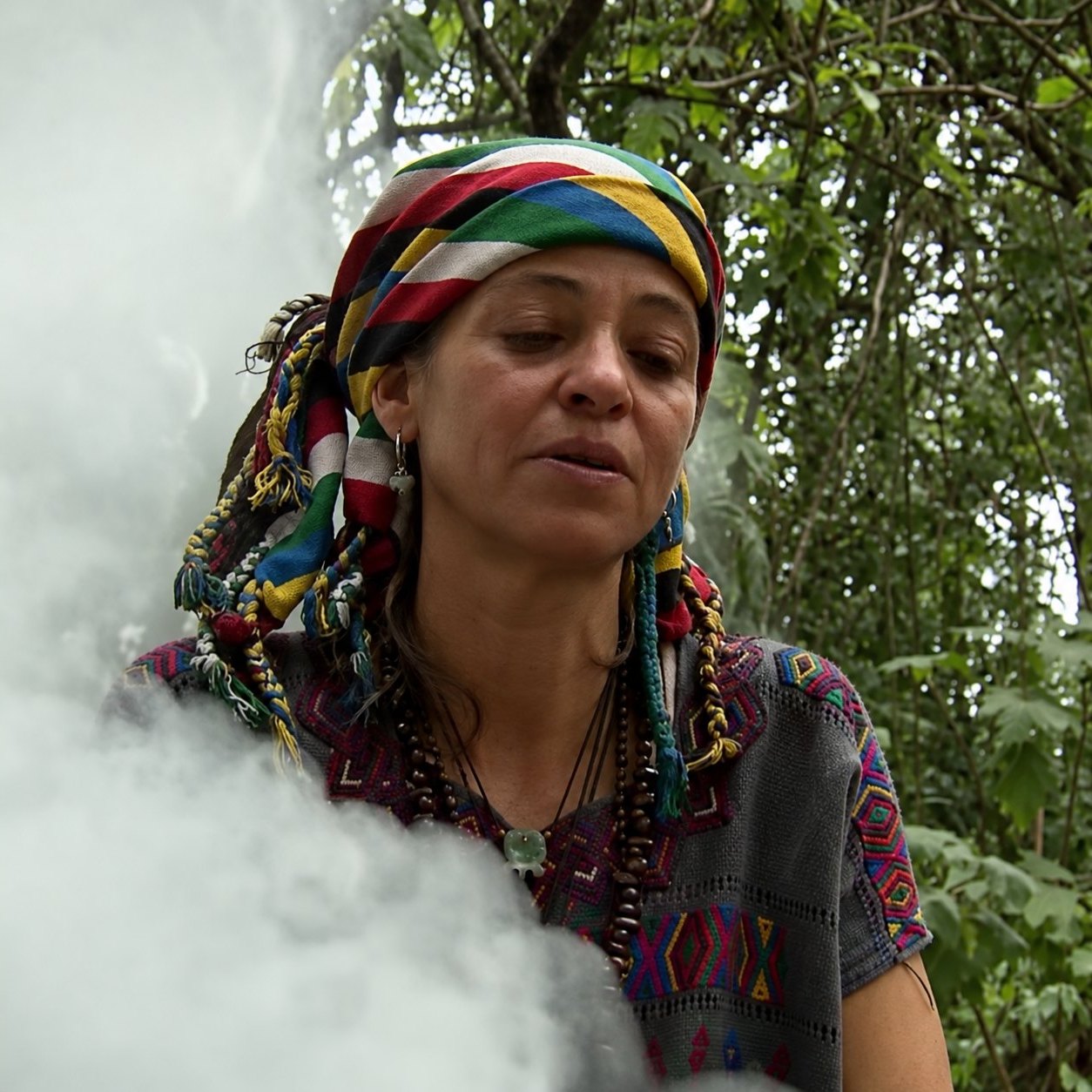 Gg, founder of Cacao Jun Ajpu and Ajq’ij, at a fire ceremony, surrounded by smoke